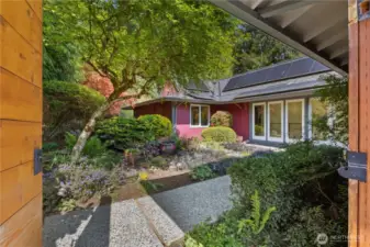 Enter the home with a beautifully landscaped pond area