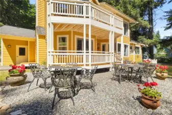 To the left of the back deck is a woodshed, access to garage and stock room for firewood that is also accessible from the living room.