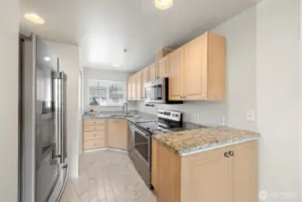 Granite Counters and newer appliances in the kitchen.