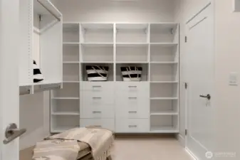 A dream walk-in closet featuring custom shelving, ample storage, and boutique-inspired design.