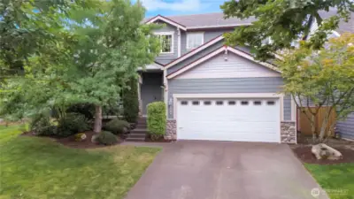 Front view of home, mature landscaping just refreshed.
