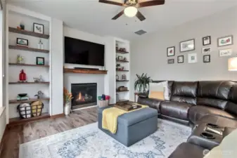 As you walk down the hall from entry, you will find this beautiful family room open to the kitchen in the back of the home. I love the coz=y has fireplace and built-in shelving!