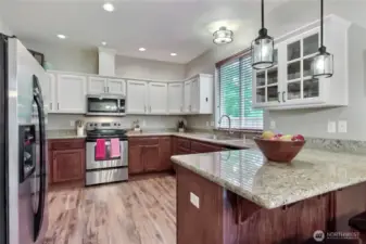 Kitchen view one, you will love the matching stainless steel appliances, contrasting white and brown cabinetry, andthe spacious granite countertops. Just beautiful.