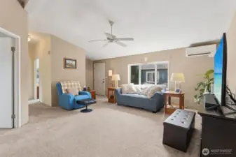 Looking from the dining room/kitchen, den on the left and hallway to 2 bedrooms and the main bathroom.