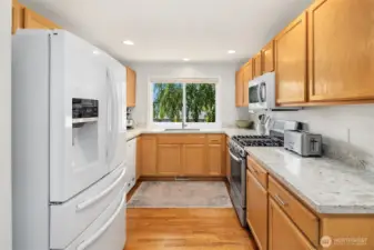 Kitchen with new quartz counter tops, sink, faucet, soft close hinges.