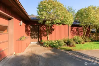 External front entry with planter box to the left.