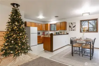 Dining room and kitchen.  Holiday tree area is where th wood stove used to be.  This could be mad into a stove area again - ceramic tile flloring and on the wall still there.  Or extend this area with a door leading into the utility area.