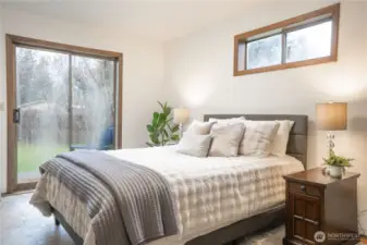 Primary bedroom, so-called because it is larger, has the sliding glass doors with a private patio, and a larger closet.