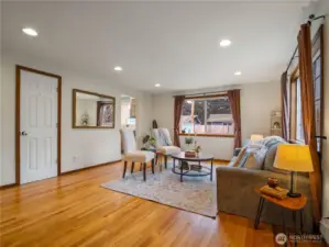 Step into the living room and experience the gleaming refurbished original hardwood floors.