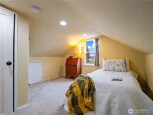 A large bedroom with interesting details and angles.