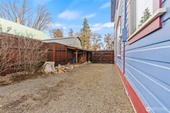 North side of the house offers a bike shed and firewood storage.