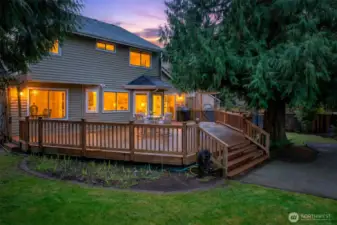 Twilight ambiance highlights the home’s warm interior glow and the inviting deck, an ideal setting for evening dining, relaxing, and entertaining.