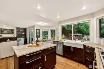 From the dining room, the flow into the updated kitchen keeps serving and gathering seamless. Kitchen updates include granite counters, an island for prep space, and stainless appliances for everyday ease.
