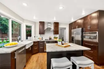 Thoughtfully remodeled, this kitchen pairs rich cabinetry with stainless appliances and abundant storage. The island workspace and wide counters make everyday cooking easy, with a layout designed to keep everyone connected.