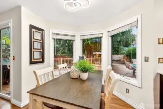 The dining nook is wrapped in windows, bringing in bright natural light and a calming view of evergreens. Sliding door access makes it effortless to step outside to the deck for outdoor dining and entertaining.