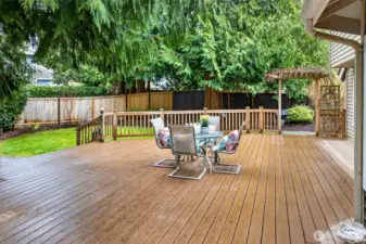 Step outside to an expansive, low maintenance deck that feels like an outdoor retreat. There is plenty of space for dining, lounging, and entertaining, with a natural evergreen backdrop that adds privacy.
