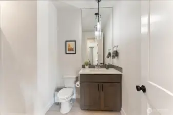 Main level guest bath thoughtfully placed across from the main level bedroom and den, creating a private, convenient guest experience.