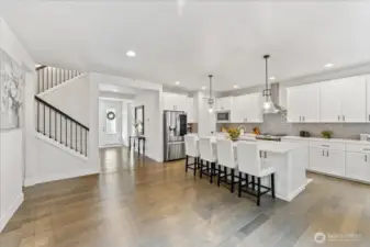 Open concept kitchen where thoughtful design, premium finishes, and abundant natural light creating an inviting space for cooking, entertaining and daily living.