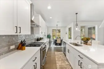An impressive array of cabinetry with black cabinet pulls, offering elegant storage solutions throughout the kitchen.