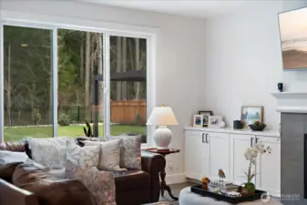 A family room adjacent to the kitchen with convenient built-ins perfect for displaying all your family photos and  storing your family games and puzzles.