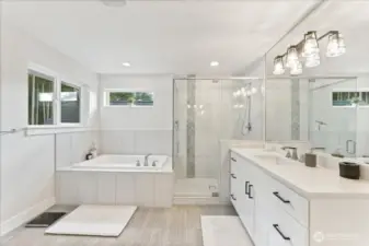 A spa-inspired five-piece Primary Bathroom with a waterfall tile shower and an oversized soaking tub elevates the entire space.