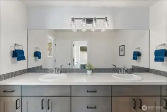 Spacious upstairs full bathroom featuring dual sinks, quartz surfaces, and tile flooring.