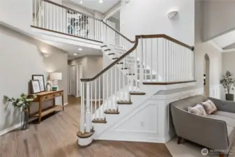 ...stunning 2 story foyer, where refinished floors and a grand staircase create a grand first impression. The entry seamlessly leads into the formal living spaces, including the living room and dining room, main floor office and hallways to convenient powder bath, laundry room and access to garage.