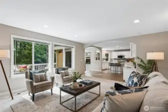 The family room adjoins the kitchen and breakfast nook, offering an open and integrated layout that blends comfort with effortless style.