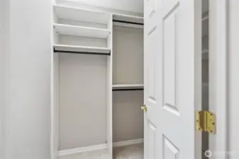 The walk in closet has a new closet system including shelving, clothing bars and...