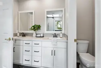 The luxurious five-piece, spa-inspired bath features dual vanities with new cabinets, sins, faucets, countertops and tile backsplash. The water closet has a new toilet too. The heated tile floors offers warm year round comfort.