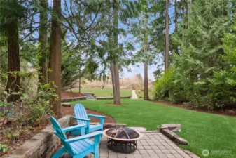 The backyard provides play areas surrounded by large evergreen trees and established landscaping. Beyond the stone walls in the back area, an orchard and pathway add to the beauty and privacy of this exceptional outdoor space. At the back of the property, there is also a gated exit to the pubic land and park down the hill below.