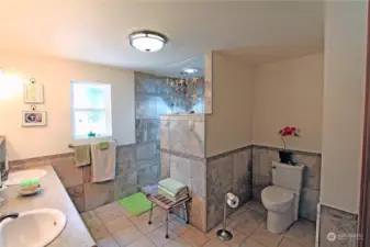 The primary bathroom features double sinks and natural light.