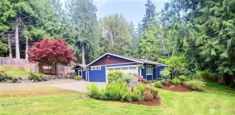 From entry drive directly to side of home and garage. Surrounded by beautiful trees and brush but the lot itself is mostly clear and allows plenty of sun in.