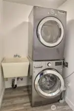 Stacked full sized washer and dryer with accompanying sink