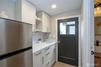Attractive cabinets with a Quartz counter and new finishes make this an inviting hang out room.