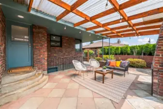 A spacious, covered patio offers the ideal setting for gatherings, rain or shine.