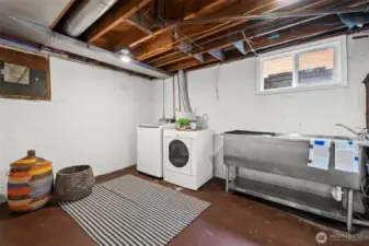Enjoy a spacious basement laundry room with an oversized utility sink that serves as a dog-washing station.