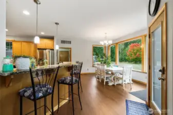 The kitchen with an expansive eating bar is designed for entertaining and gatherings.