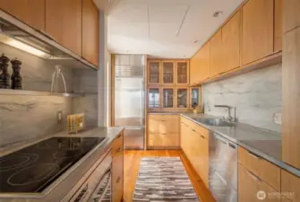Custom bleached Walnut cabinetry and top-of-the-line appliances.