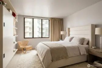 Primary bedroom with double windows for noise control also has an AV cabinet/book shelf wired for TV and speakers for bedroom and bath.