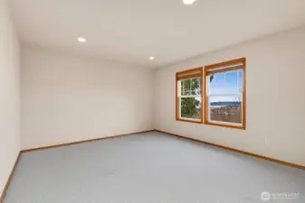 Bedroom 3 of 4 on upper level. This spacious bedroom offers a walk-in closet.