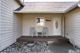 Covered front porch sitting area.