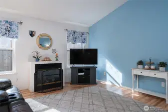 A cozy gas fireplace warms the space.