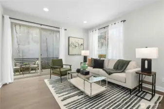 Main living at top of stairs with oversized sliding glass door to the first private balcony.