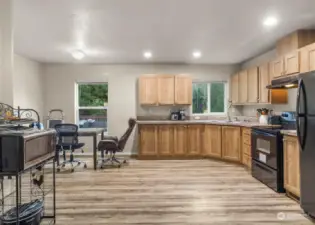 Large Kitchen with plenty of space for a future island! The beautiful LVP flooring carries throughout. Fridge and Stove stay.