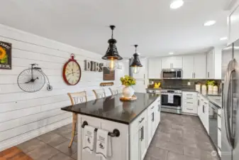 Welcome to the HUGE gourmet kitchen! Replete with cabinets & countertops galore, and a beadboard wall, great for your own photo wall or decorative choices!