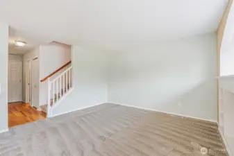 Living room. Foyer to the left to the front door, garage entrance and 1/2 bath as well as the staircase to the upper level.