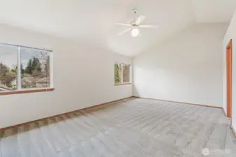 Spacious primary bedroom at back of home for peace and quiet. The primary bathroom has double sinks, toilet and shower.