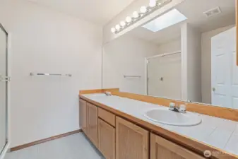 Primary bath, double sinks, toilet and shower.