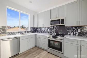 This kitchen showcases the lay out and high-quality finishes you can expect in the newly constructed residence at 8608 42nd Ave S, Seattle, WA 98118, built by the same builder.